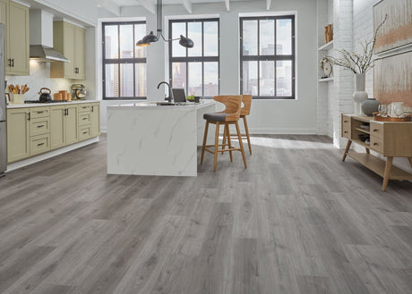 ReNature by CoreLuxe 6.5mm w/pad Toledo Oak Waterproof Rigid Vinyl Plank Flooring in large open kitchen area