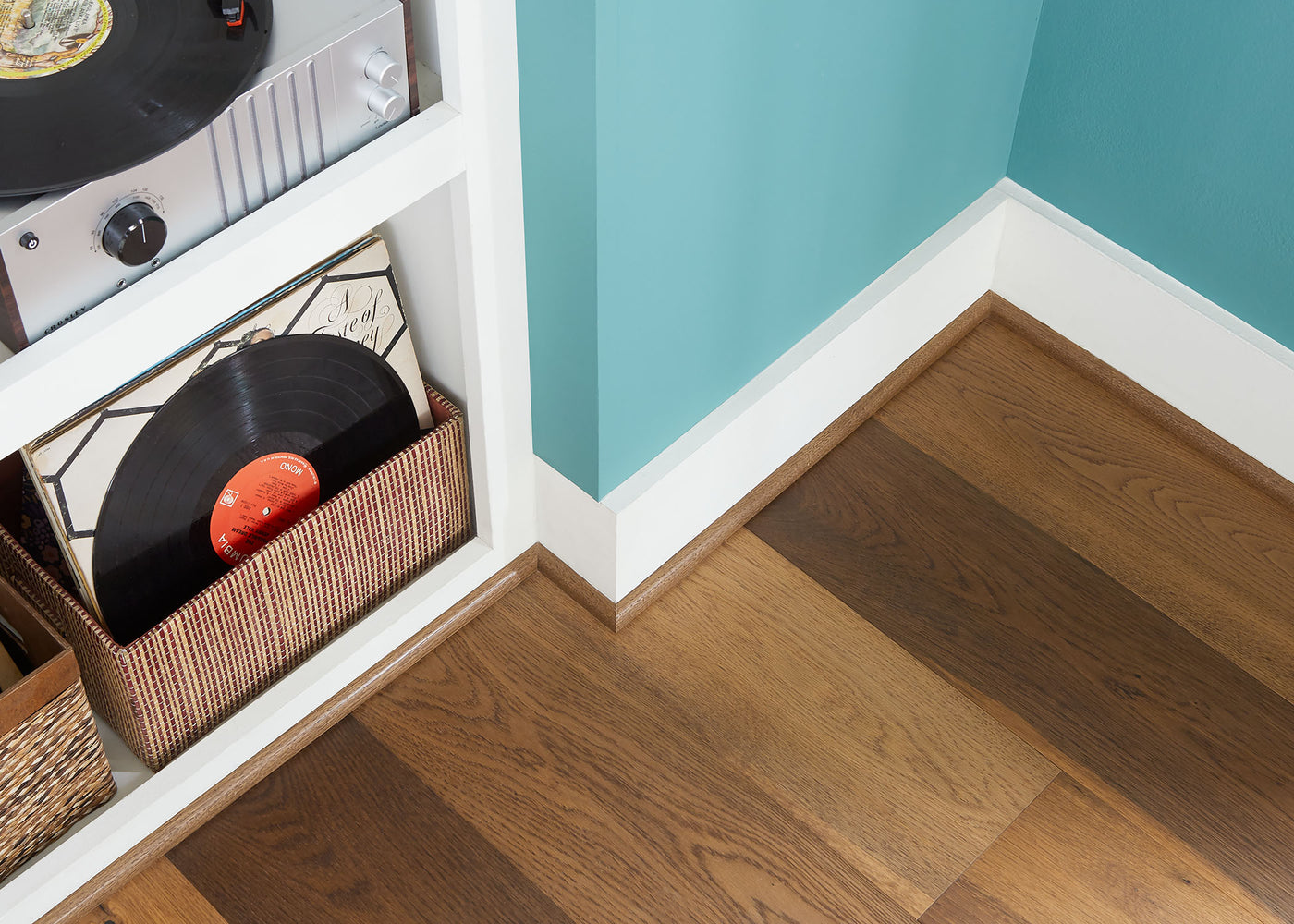 Music room with hardwood flooring, white baseboard, and matching quarter round.