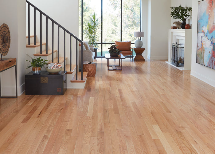 Open space and stairs with Builder's Pride Red Oak Solid Hardwood Flooring