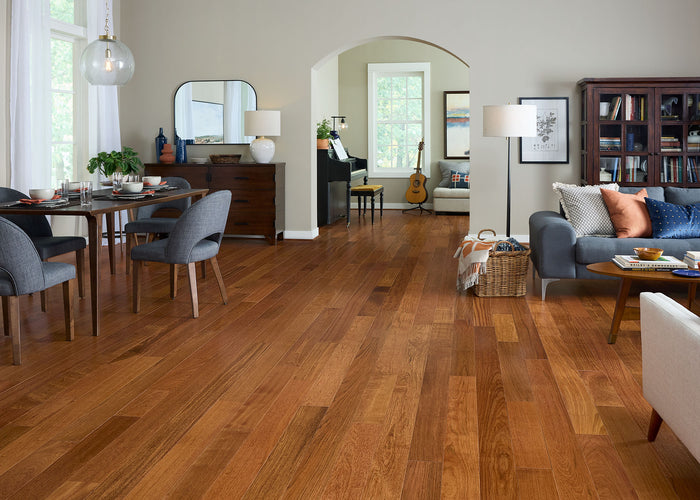 Open space living room and dining room with Bellawood Brazilian Cherry Prefinished Solid Hardwood Flooring
