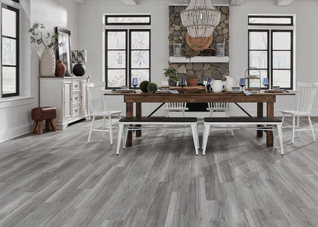 CoreLuxe 5mm w/pad Table Rock Oak Waterproof Rigid Vinyl Plank Flooring in an open dining room