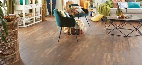 5mm Copper Ridge Oak Waterproof Luxury Vinyl Plank Flooring 6.65 in. Wide x 48 in. Long installed in a living room with a green chair and other decor.