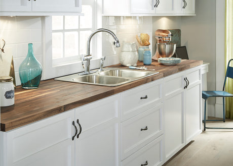 A kitchen sink setting featuring American Walnut Butcher Block counter top