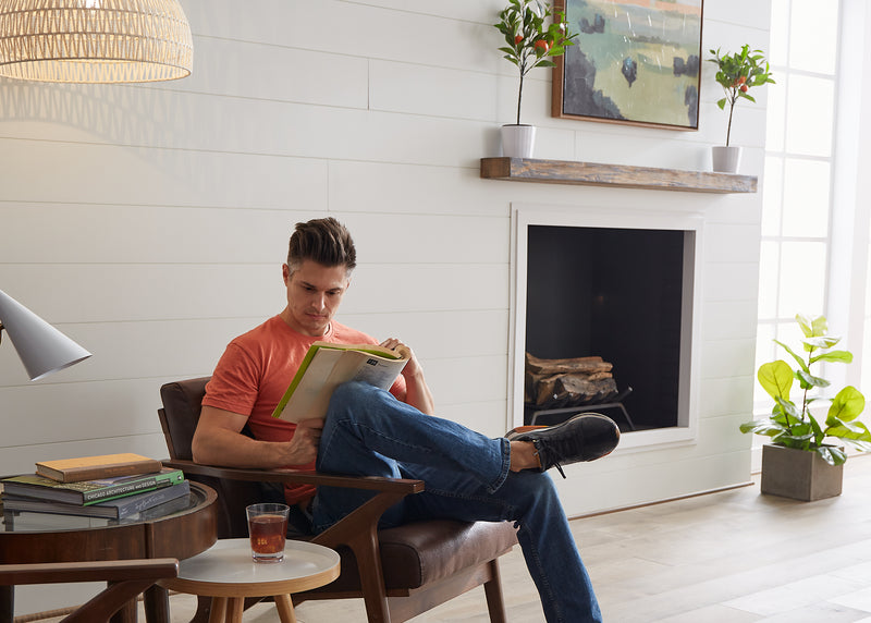 Shiplap wall decor installed onto a wall with a fireplace in a living room.